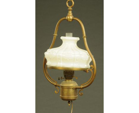 A late 19th century brass oil lamp, hanging, with opaque glass shade.  Height +/- 64 cm.  CONDITION REPORT: The shade appears