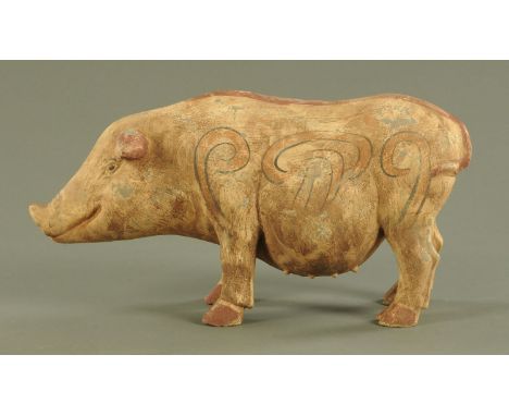 A Chinese Tang style pottery model of a sow, with painted scroll decoration in russet and outlined in black.  21.5 cm high, 4
