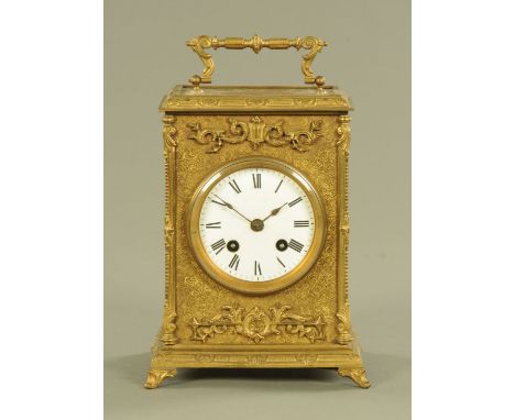 A 19th century brass mantle clock, with enamelled dial and two train striking movement.  Height 22 cm, width 17 cm.