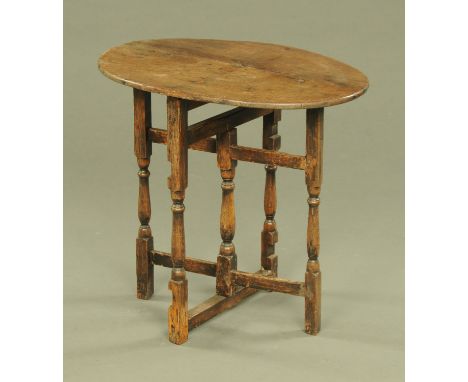 An oak and mahogany folding gate leg table.  top 68 cm x 49 cm.