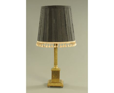 A brass table lamp, with fluted column and stepped base.  Height including shade 84 cm.