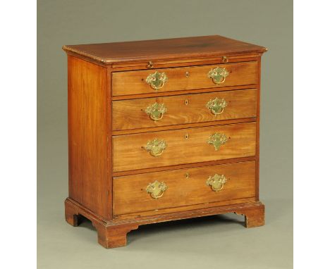 A Georgian red walnut chest of drawers, with moulded edge and brushing slide above four long graduated drawers with brass dro