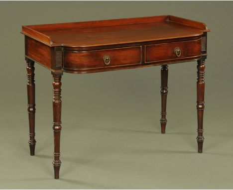 A Regency mahogany desk or dressing table in the manner of Gillows, with three quarter low gallery and two frieze drawers and