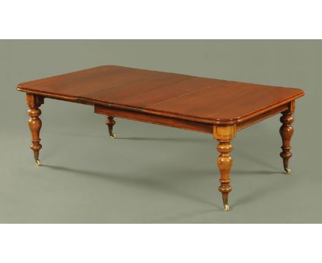 A Victorian mahogany pull out extending dining table, rectangular top with rounded corners and moulded edge supported upon fo