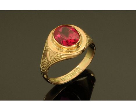 A 9 ct gold gentleman's ring, set with an oval ruby, size Q/R, 6 grams (see illustration).  