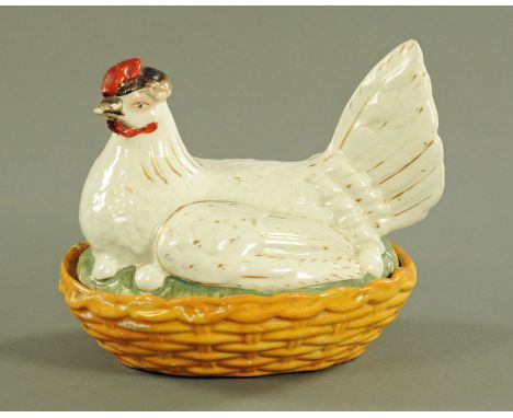 A 19th century Staffordshire hen on nest egg cruet, with red comb and white body highlighted with gilding.  Length 21 cm (see