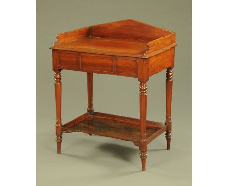 A Victorian mahogany washstand, with three quarter gallery and hinged top to basin aperture, raised on turned legs united by 