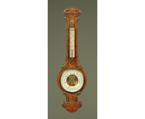 A Victorian carved oak aneroid barometer, 89 cm high. CONDITION REPORT: The case is in generally good order.  The moulding ab