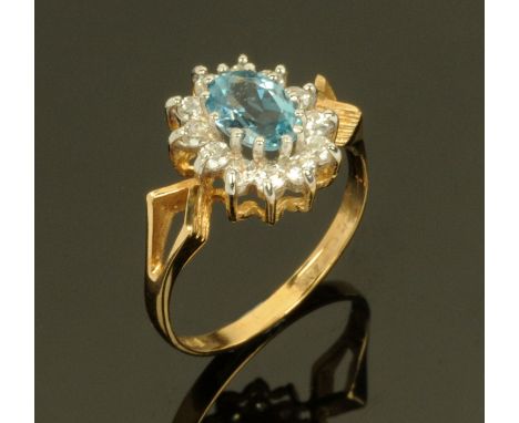 A 9 ct gold blue topaz and diamond cluster ring, yellow gold shank. Size N/O.