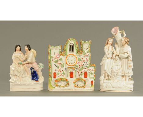 Two Staffordshire pottery figural spill vases, one modelled as Rebecca and Elijah standing at the well, one modelled as a Got