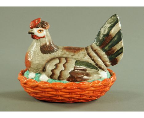 A 19th century Staffordshire hen on nest egg cruet, coloured bird, green and brown wings and tail, red comb, orange base.  Le