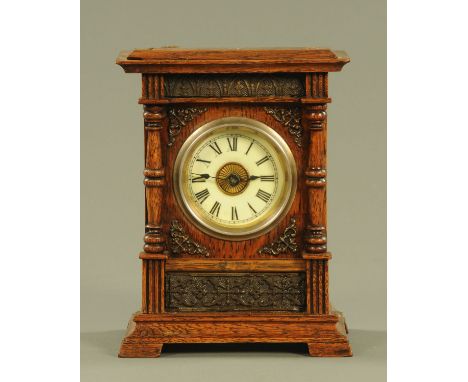 A late 19th century oak cased mantle clock, with two-train movement, alarm and musical comb.  Height 19 cm, width 15 cm.  CON