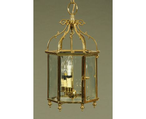 A brass hanging lantern light fitting, with three bulbs, glass panels and door.  Height to top of hanging loop 58 cm. CONDITI