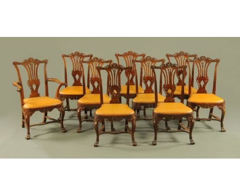 A set of one carver arm and eight single mahogany dining chairs, in the George II style, with pierced splat backs and drop in