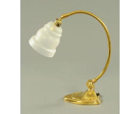 An adjustable brass desk lamp, with frosted glass shade on ball socket, having an adjustable stem on stylised heart shaped we