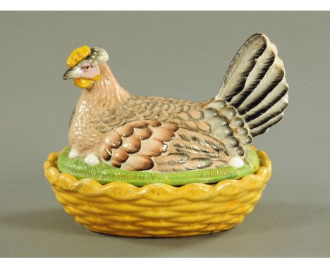 A 19th century Staffordshire hen on nest egg cruet, yellow base, yellow comb, coloured bird.  Length 21 cm. CONDITION REPORT: