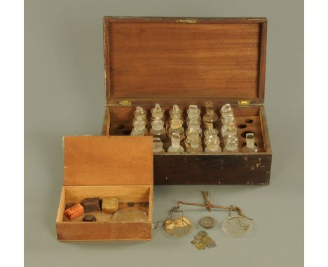 A mahogany case of apothecary bottles, (21), each +/- 9 cm, and a cased pair of apothecary scales.