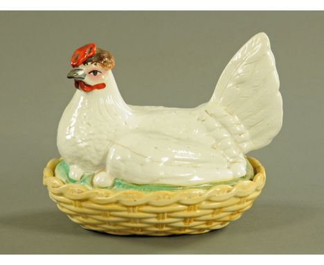 A 19th century Staffordshire hen on nest egg cruet, pale yellow base, red comb, brown head.  Length 22 cm. CONDITION REPORT: 