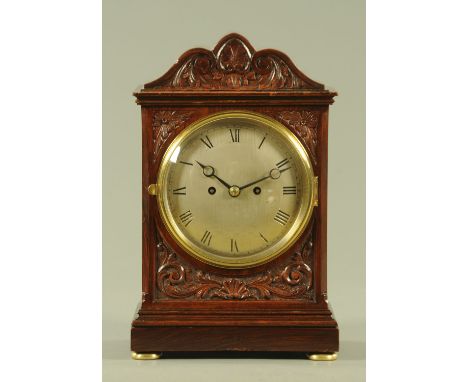 A good late Victorian carved mahogany double fusee bracket clock, the slightly bowed silvered dial engraved with Roman numera