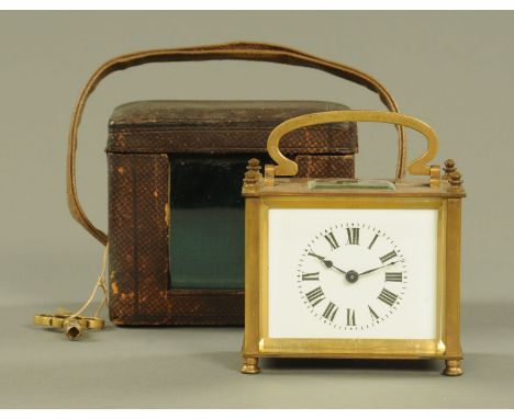 A brass carriage clock, rectangular, timepiece only, complete with carrying case and key.  Width 9.5 cm, height excluding car