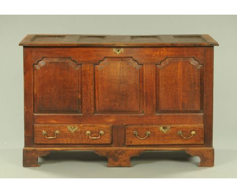 A George III oak mule chest, with three shaped panels above two drawers and all raised on bracket feet.  Width 143.5 cm. 