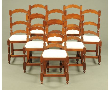 A set of eight mahogany ladder back dining chairs, each with drop in seats and raised on legs of square section with stretche