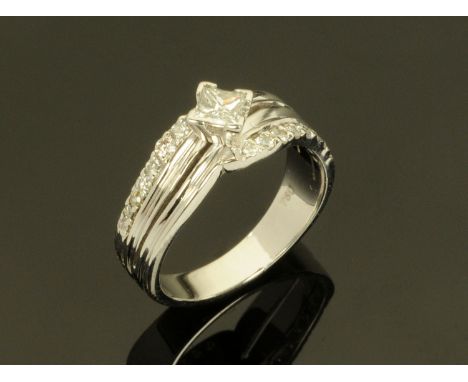 An 18 ct white gold three row diamond ring, centre diamond +/- 0.35 carats. CONDITION REPORT: The ring size is L/M.  It is in