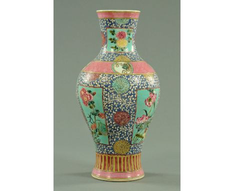 An Oriental vase, decorated with chrysanthemums and other designs in polychrome and with six character pseudo Kangxi mark to 