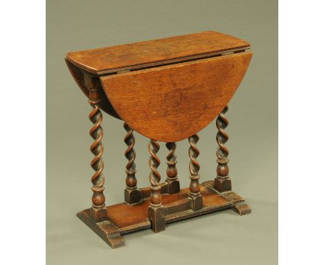 A late 19th/early 20th century oak gate leg occasional table, with barley sugar twist supports and low flat stretcher. Width 