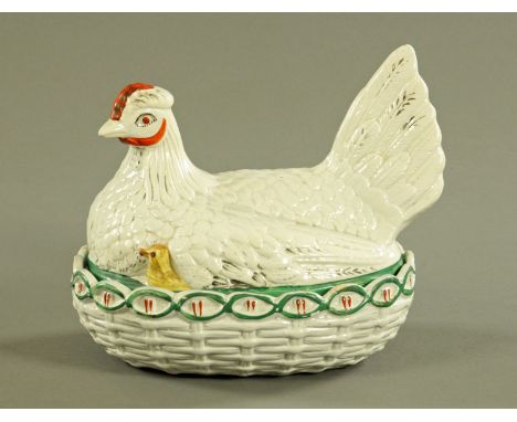 A 19th century Staffordshire hen on nest egg cruet, chick showing, green band to top of nest, red comb.  Length 24 cm. CONDIT