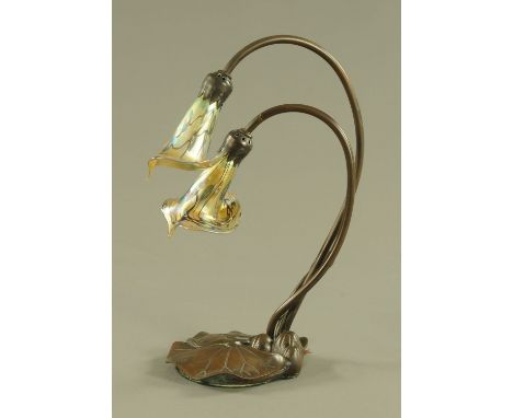 An Arts and Crafts metal table lamp, with two glass shades and water lily leaf base, height 39 cm. CONDITION REPORT: The ligh