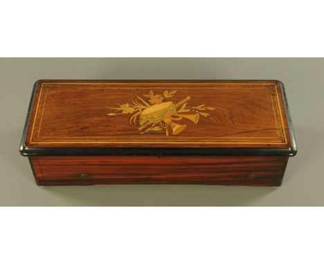 A 19th century Swiss rosewood musical box, with 32 cm comb and playing 8 airs.  Length 57 cm (see illustration).  CONDITION R