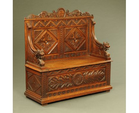A late 19th/early 20th century carved oak monks bench.  Width 120 cm. 