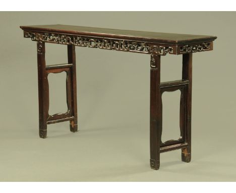 A 19th century Chinese hardwood altar table, with pierced frieze and raised on moulded legs with stretchers and inner frames.