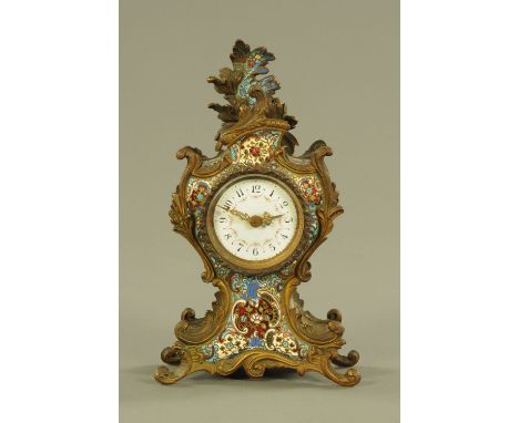 A 19th century French Champleve enamel mantle clock, with Rococo case and enamelled dial with single train movement.  Height 