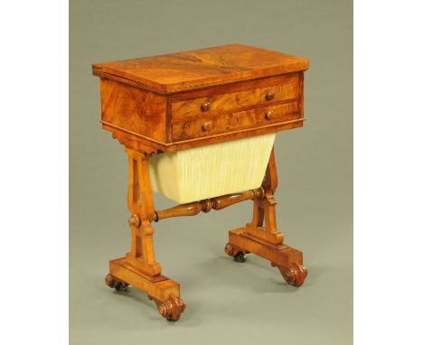 A Victorian walnut games/worktable, with turnover top and red tooled leather playing surface, fitted with two drawers, one st