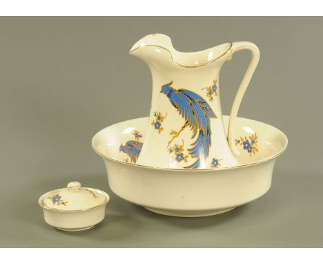 A toilet jug and basin set, circa 1930, decorated with an exotic bird.  Bowl diameter 39 cm. CONDITION REPORT: Jug height 33 