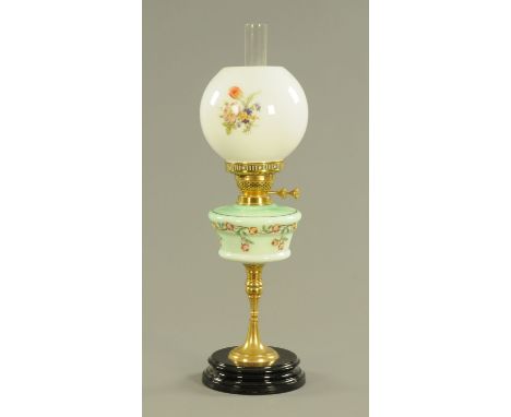An oil lamp, with green glass reservoir and brass column.  Height including chimney 64 cm. 