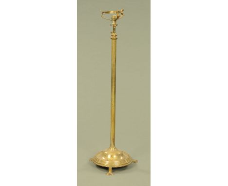 A 19th century brass lamp standard, with circular base raised on three short feet. CONDITION REPORT: Height 128 cm.  Height w
