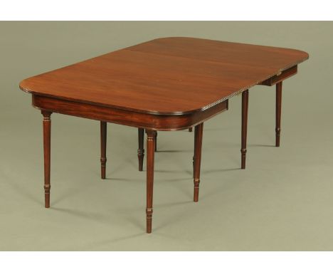 A George III mahogany dining table, comprising two D ends and one leaf with centre gate leg and raised on simple turned legs.