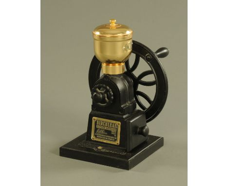 A Birchleaf of London coffee grinder, raised on a wooden stand, height 28 cm. CONDITION REPORT: The coffee grinder is in extr