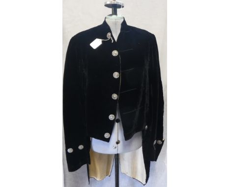 VINTAGE: A BLACK VELVET 'FOOTMAN' STYLE COAT, with metal cut buttons to the front 