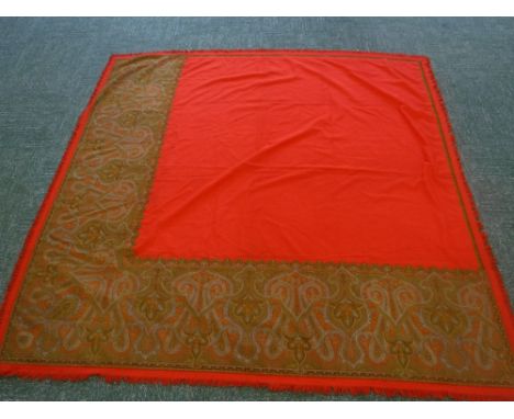 VINTAGE: A LARGE RED SHAWL, decorated to the outer edge with a paisley design inserted panel 