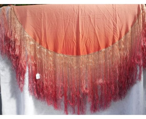 A VINTAGE SILK PIANO SHAWL in peach bleeding through to dusky pink, with long fringing, circa 44" x 46" (brown spots to cover