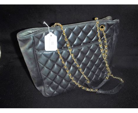 VINTAGE BLACK QUILTED HANDBAG: 'Chanel' style, with chain arm strap