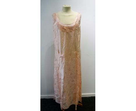 A FULL LENGTH LIGHT PINK NIGHTDRESS with tie waistline, the shoulders joined by three thin straps, decorated throughout with 