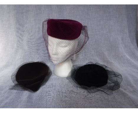 A VINTAGE BLACK VELVET PILL-BOX HAT, decorated with fine net and two others similar