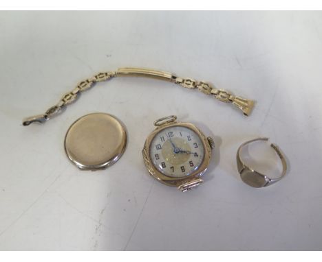 A 9ct yellow gold ladies manual wind wristwatch on a 14ct sprung strap, and a 9ct cut ring, back off watch, strap weight appr