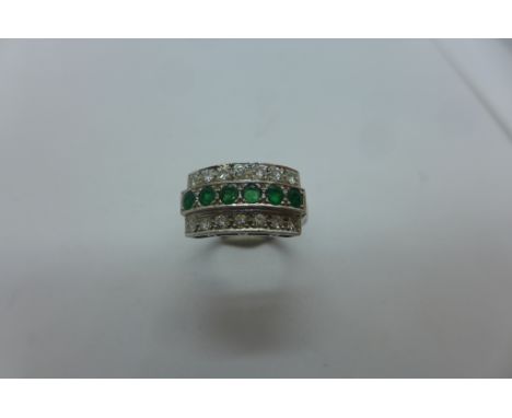 A hallmarked 18ct white gold three row emerald and diamond ring, size O, approx 7.4 grams, generally good 