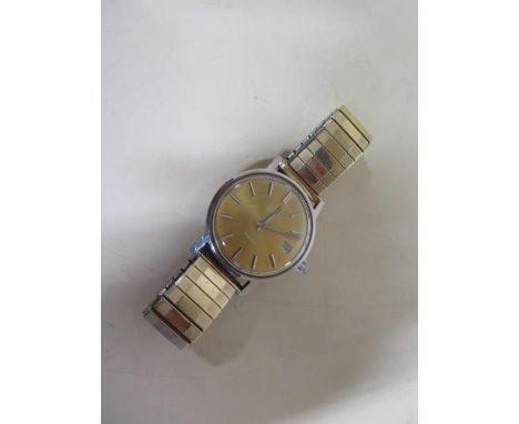 A vintage Omega Geneve automatic gents wristwatch with date, 34mm case on a sprung strap, some usage marks and wear, running,